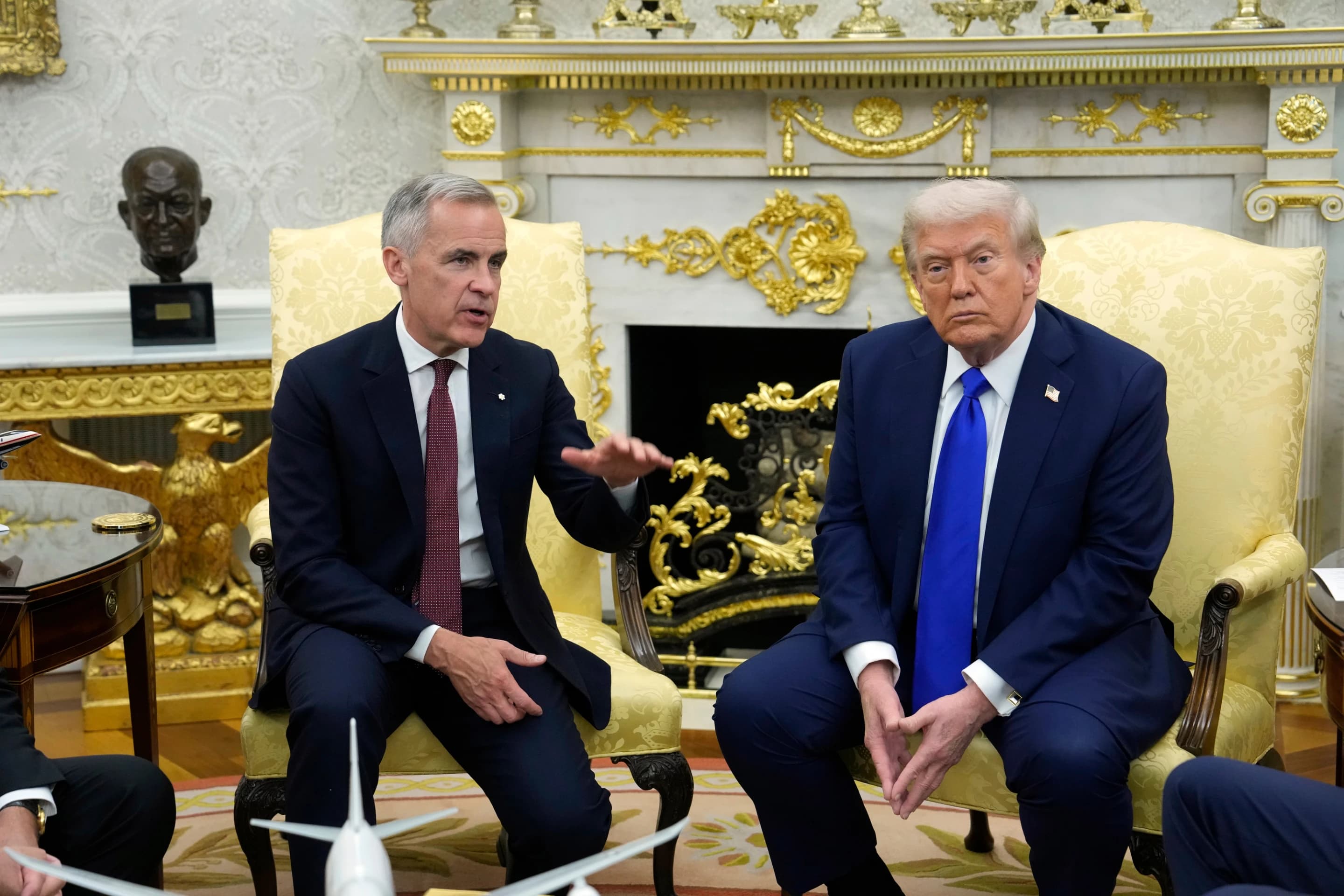 President Trump and Canadian Prime Minister Mark Carney seated together during a meeting in the Oval Office.