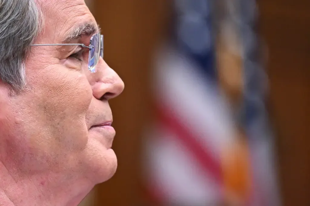 Treasury Secretary Scott Bessent in profile in front of an American flag